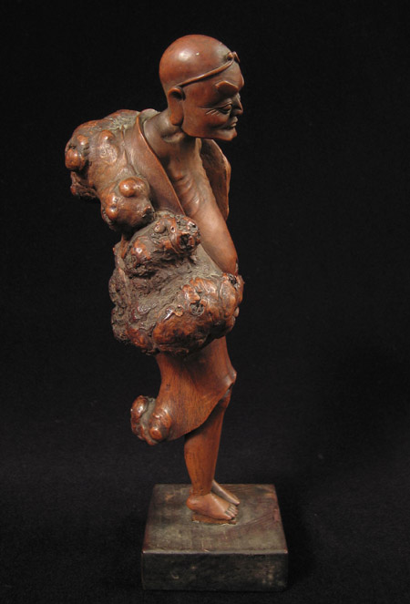Asian Tribal Art - Male figure, China, left
